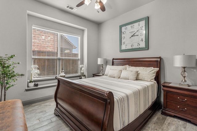 bedroom with ceiling fan and light hardwood / wood-style floors