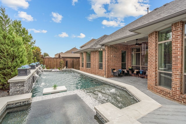 view of swimming pool with pool water feature, a jacuzzi, and a patio