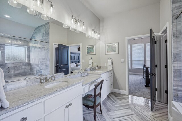 bathroom with vanity, lofted ceiling, and walk in shower