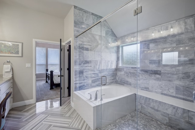 bathroom with vanity, vaulted ceiling, plenty of natural light, and shower with separate bathtub