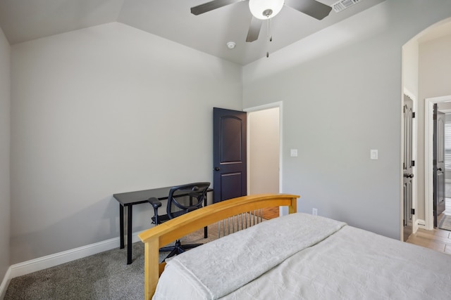 bedroom with carpet flooring, vaulted ceiling, and ceiling fan