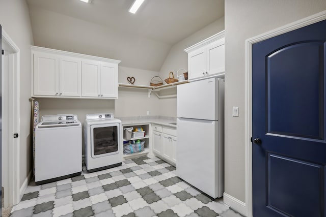 washroom with cabinets and washer and dryer