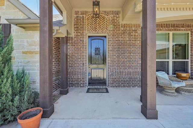 doorway to property with brick siding