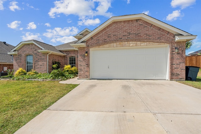 view of front of house featuring a garage and a front lawn