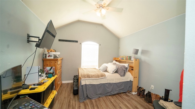 bedroom with ceiling fan, lofted ceiling, and wood-type flooring