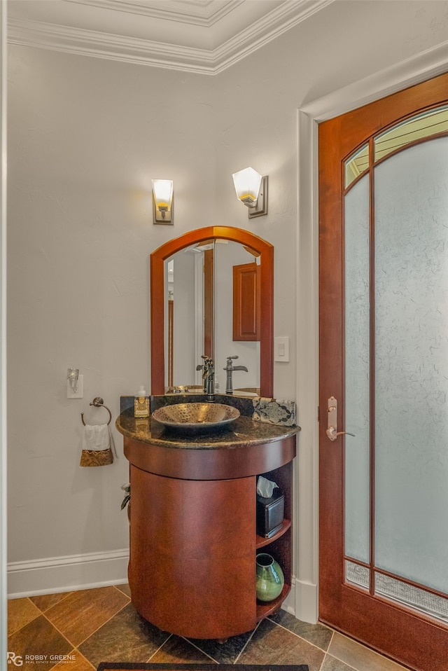 bathroom featuring vanity, tile patterned floors, and crown molding