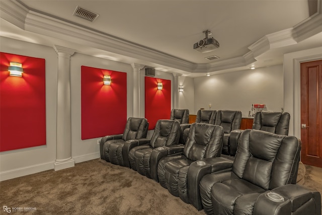 carpeted home theater featuring a raised ceiling and crown molding