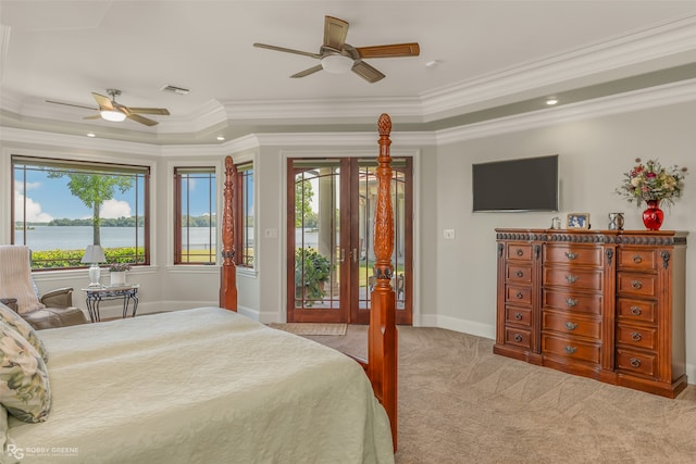 carpeted bedroom with a water view, crown molding, and multiple windows