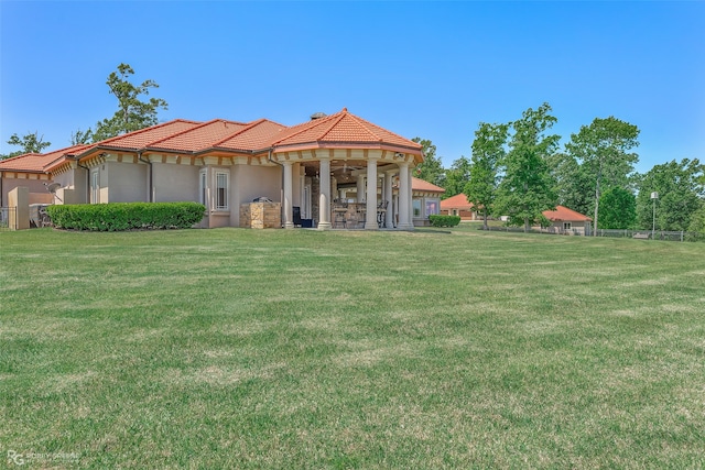 rear view of property featuring a lawn