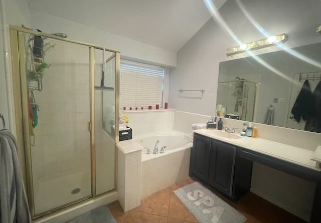 bathroom with plus walk in shower, tile patterned floors, vaulted ceiling, and vanity