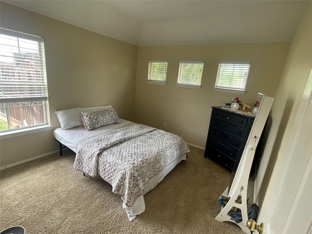 bedroom with carpet flooring and vaulted ceiling