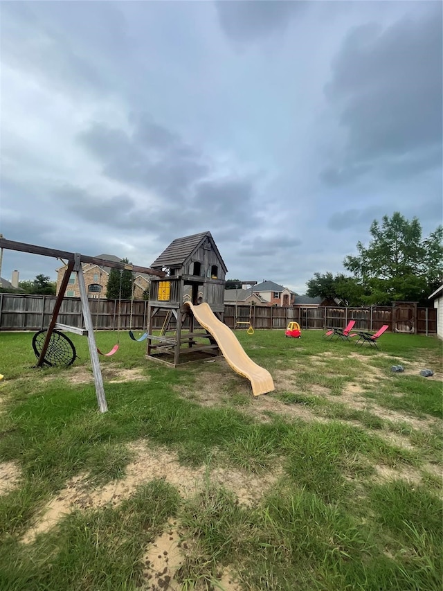 view of playground with a lawn