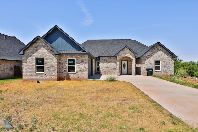 french provincial home with a front yard