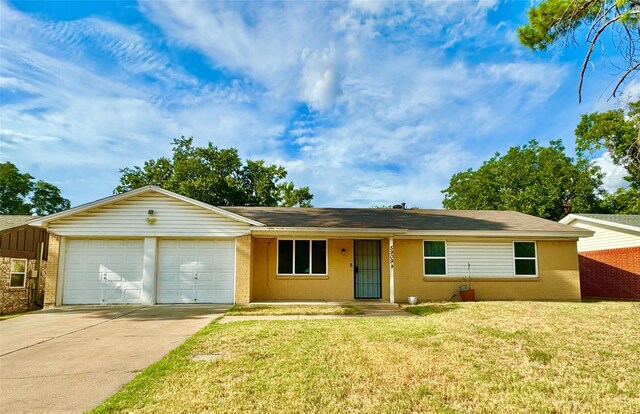 single story home featuring a garage and a front lawn