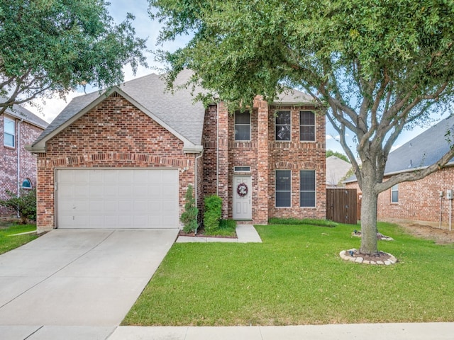 view of front of property featuring a front lawn and a garage