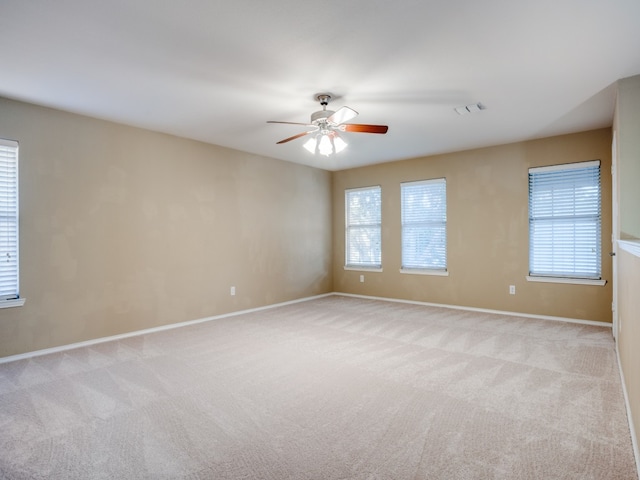 unfurnished room featuring ceiling fan and light colored carpet