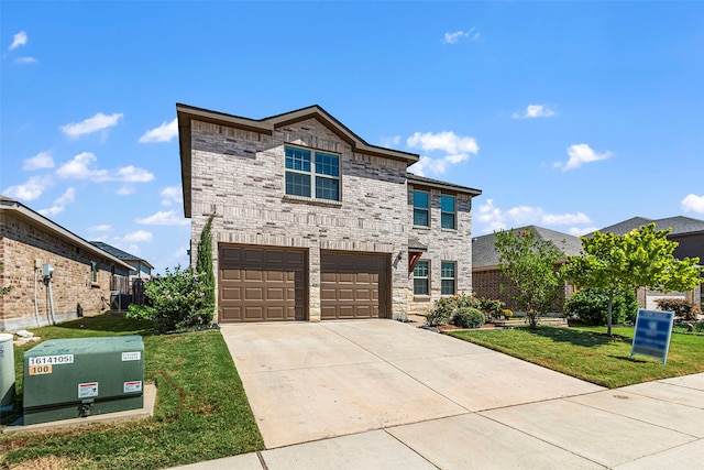 view of front facade with a garage and a front lawn