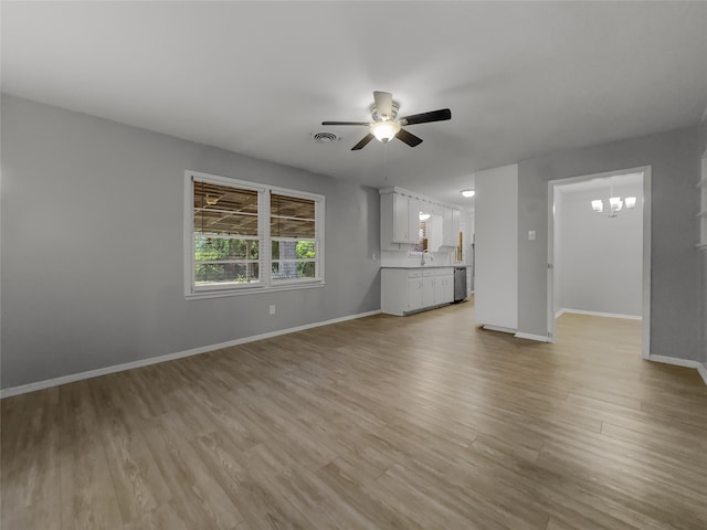 unfurnished living room with ceiling fan, sink, and light hardwood / wood-style flooring