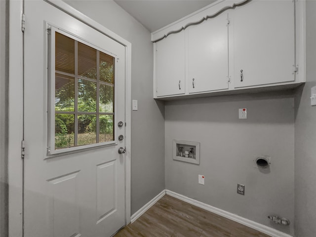 laundry area with hookup for a washing machine, cabinets, hookup for an electric dryer, and dark hardwood / wood-style floors