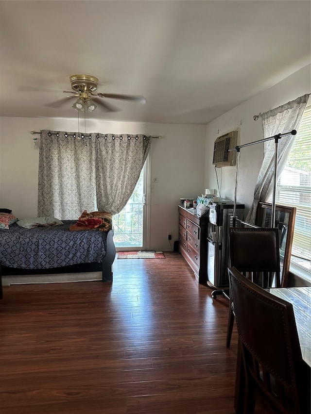 bedroom featuring multiple windows, ceiling fan, a wall unit AC, and dark hardwood / wood-style floors