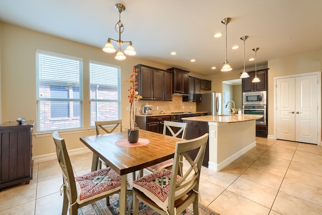 dining space featuring light tile patterned floors and a notable chandelier