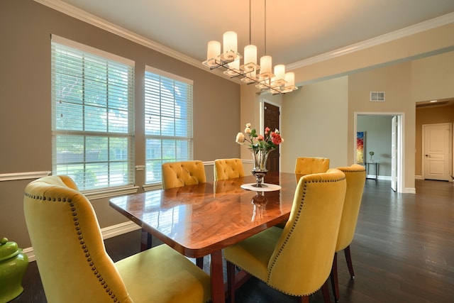 dining room with dark wood-type flooring, ornamental molding, and a notable chandelier