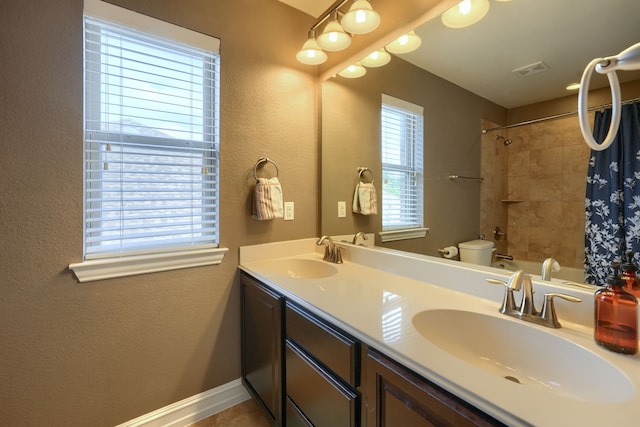 full bathroom with toilet, tiled shower / bath combo, and vanity