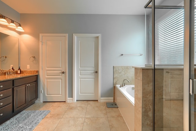 bathroom with tile patterned flooring, separate shower and tub, and vanity