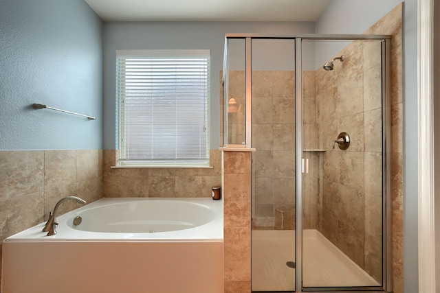 bathroom with separate shower and tub