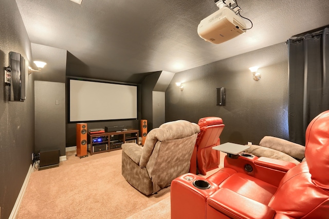 home theater room featuring vaulted ceiling, carpet, and a textured ceiling