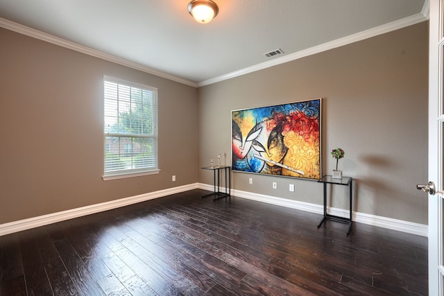 empty room with dark hardwood / wood-style flooring and ornamental molding