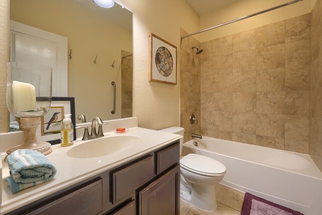 full bathroom with vanity, toilet, tiled shower / bath combo, and tile patterned floors