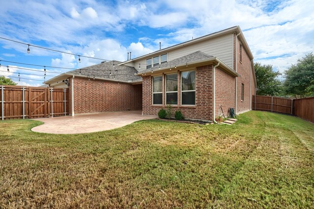 rear view of property with a patio area and a lawn