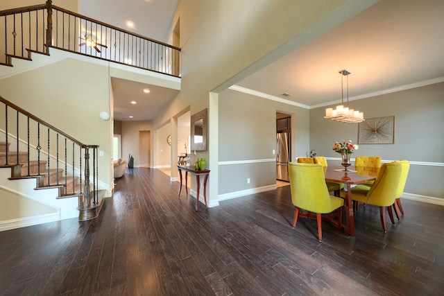 dining area featuring ornamental molding, a notable chandelier, and dark hardwood / wood-style floors