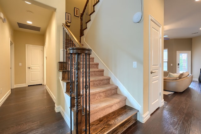 stairs featuring hardwood / wood-style floors