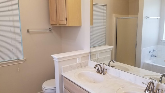 full bathroom featuring toilet, shower with separate bathtub, and vanity