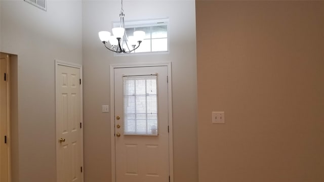 entryway featuring an inviting chandelier