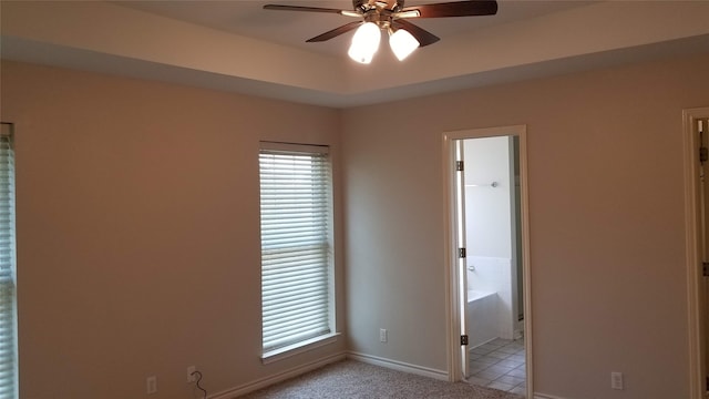 tiled spare room with ceiling fan