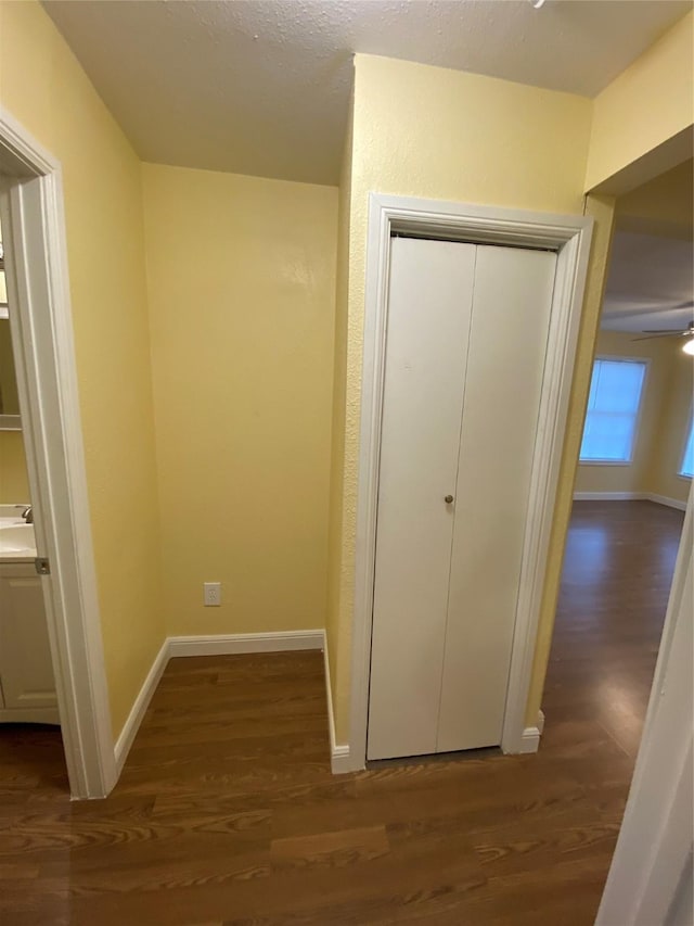 unfurnished bedroom with dark wood-type flooring and a closet