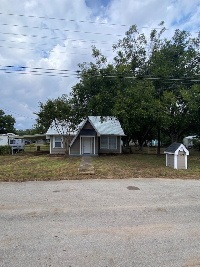 view of front of home featuring a storage unit