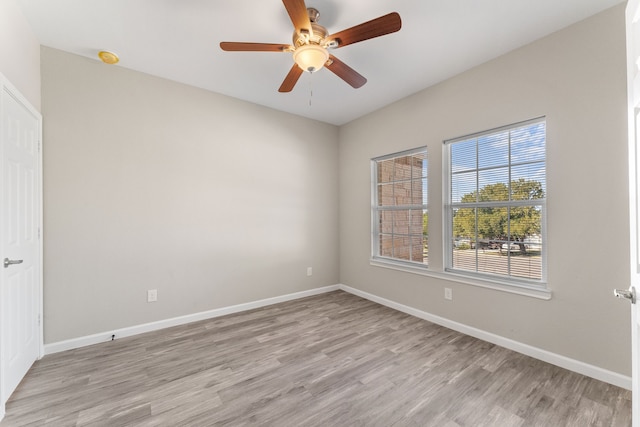 empty room with ceiling fan and light wood-type flooring