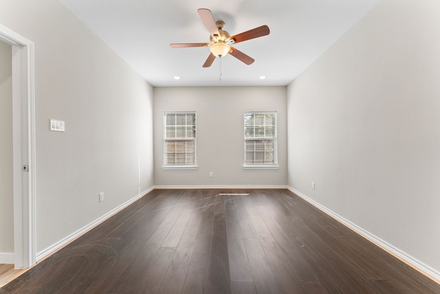 empty room featuring ceiling fan and dark hardwood / wood-style flooring