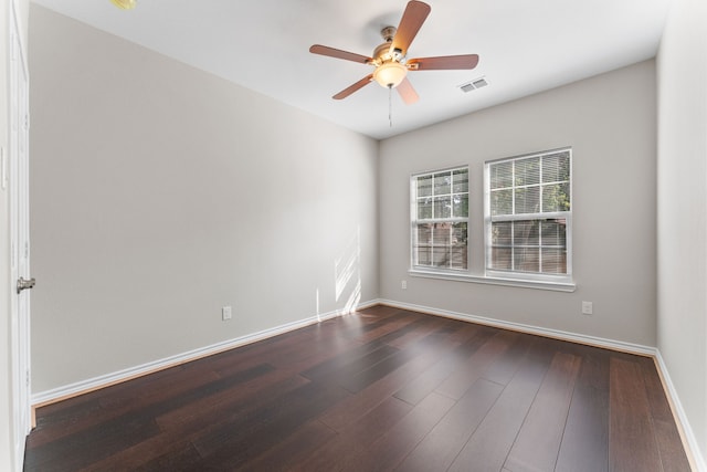 empty room featuring dark hardwood / wood-style flooring and ceiling fan