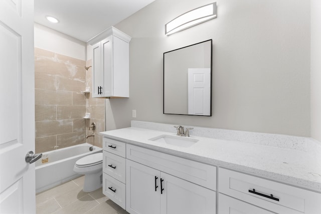 full bathroom with tiled shower / bath combo, vanity, tile patterned floors, and toilet