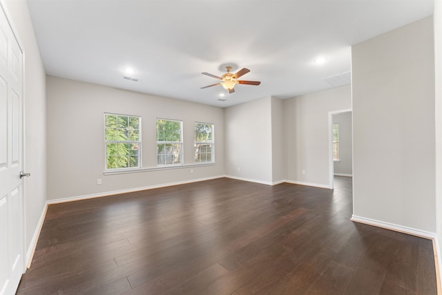 spare room featuring ceiling fan and dark hardwood / wood-style flooring