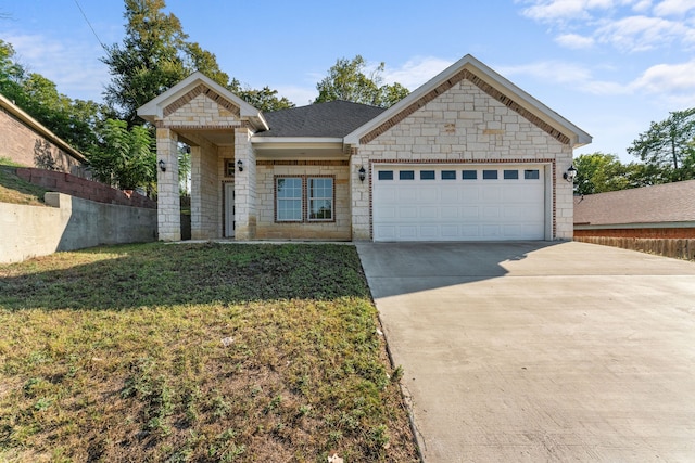 view of front of home featuring a garage and a front lawn