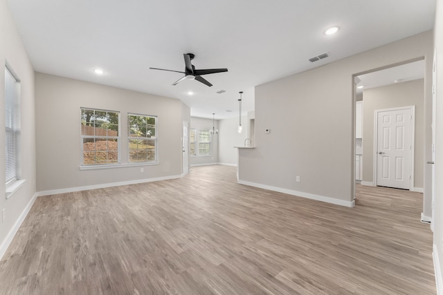 unfurnished living room featuring ceiling fan and light hardwood / wood-style flooring