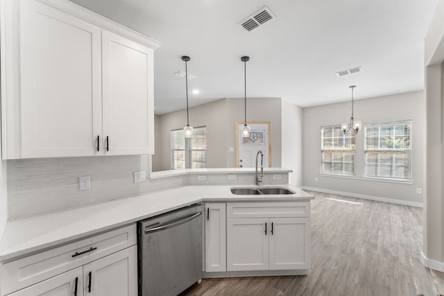 kitchen with white cabinetry, dishwasher, and sink