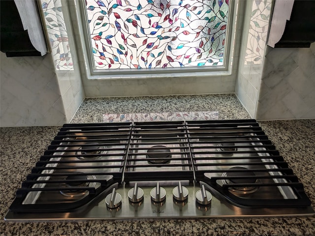 details with stainless steel gas cooktop and stone counters