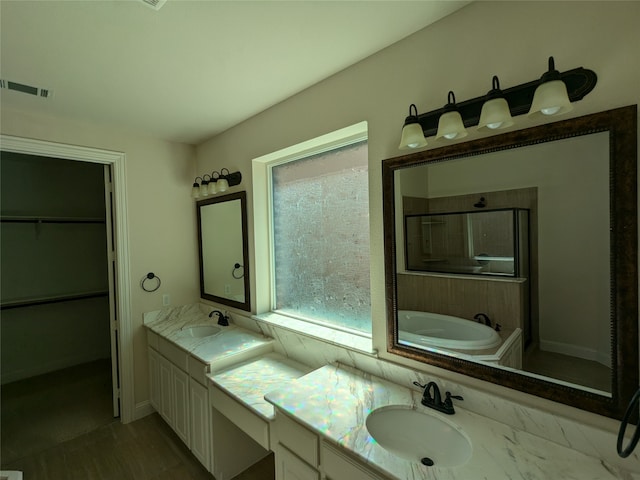 bathroom featuring independent shower and bath and vanity